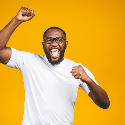 Portrait of excited young African American male screaming in shock and amazement. Surprised man looking impressed, can't believe his own luck and success